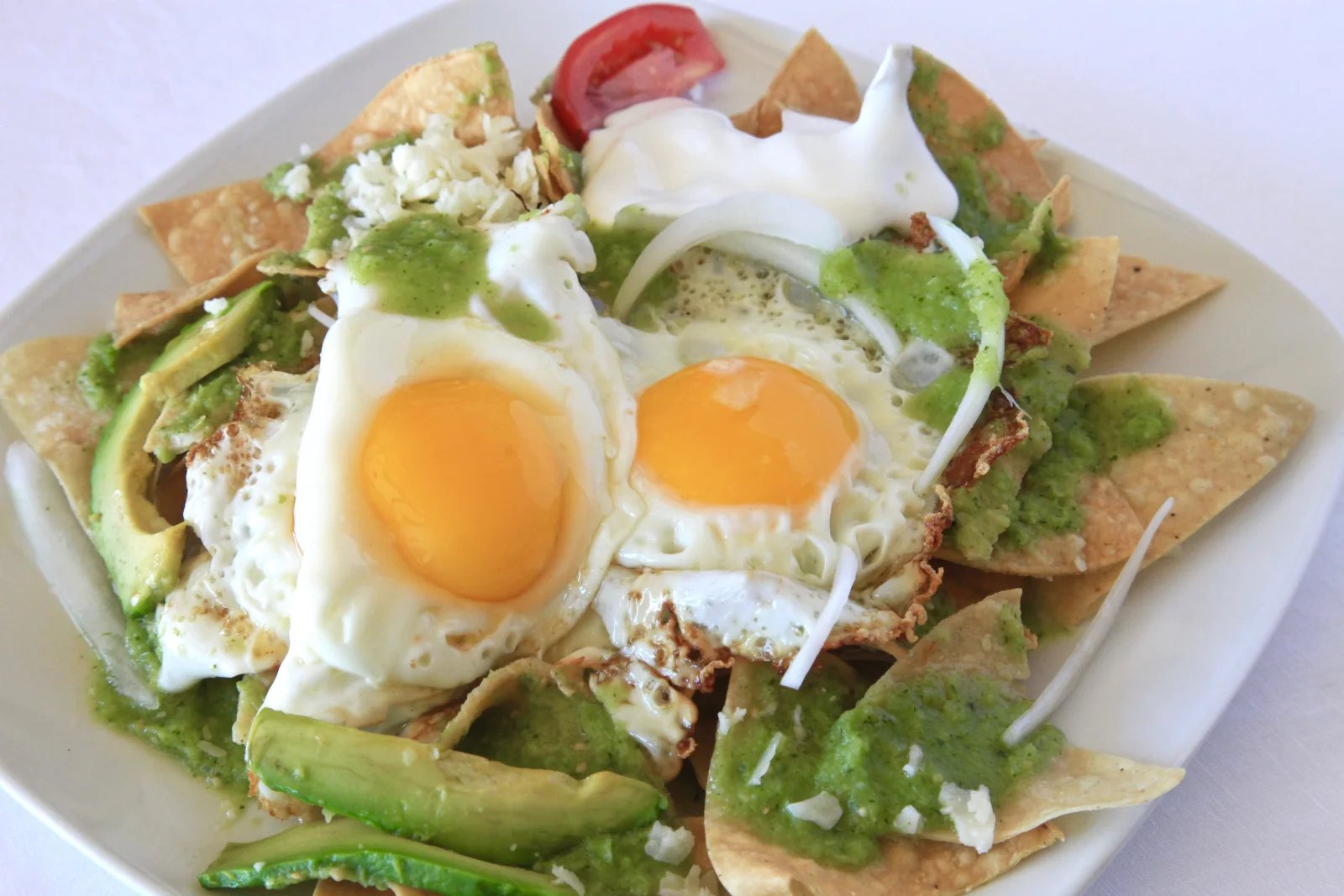Chilaquiles with eggs, salsa verde and avocado