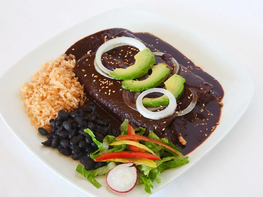 Mole enchiladas with rice, black beans, avocado, and salad